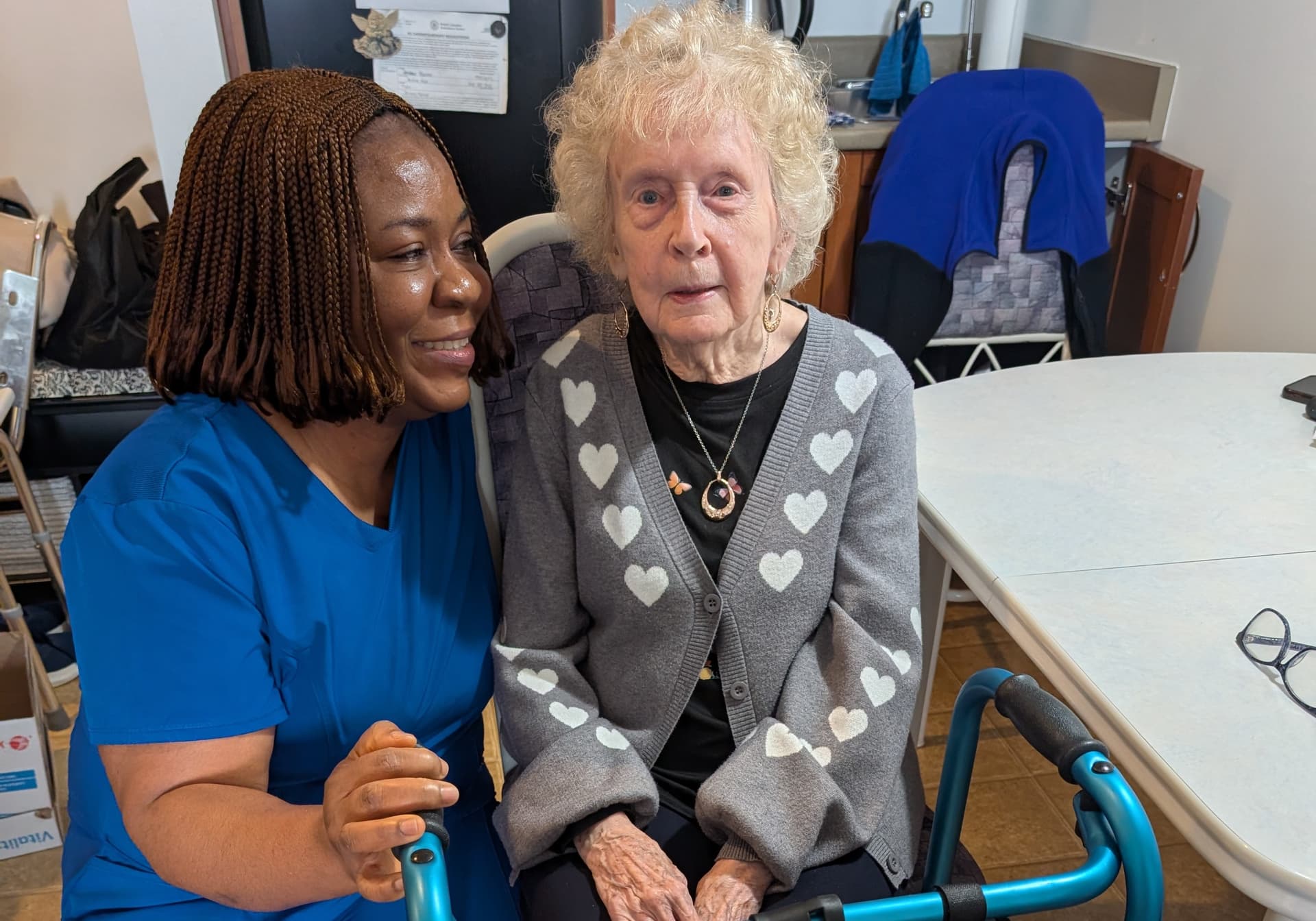 A caregiver sharing a warm moment with an elderly client at home